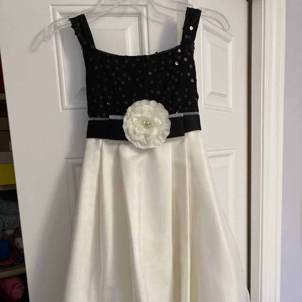 Gorgeous girls party dress in light cream/white with black sequins and rosette.